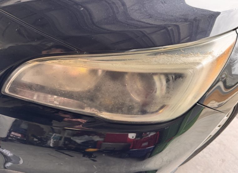 Yellowed Buick headlight with oxidation at the edge