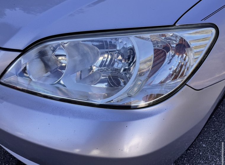 The same Civic headlight restored and clear
